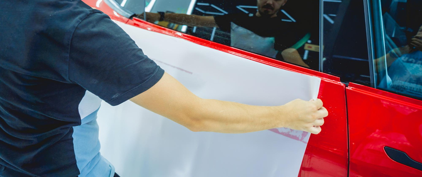 Vehicle Wrap Vinyl Products at Bi Wize Technician applying vehicle wrap vinyl to a car door for commercial branding in Thomastown